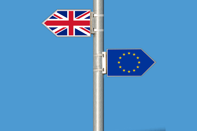 british and eu flags on a pole